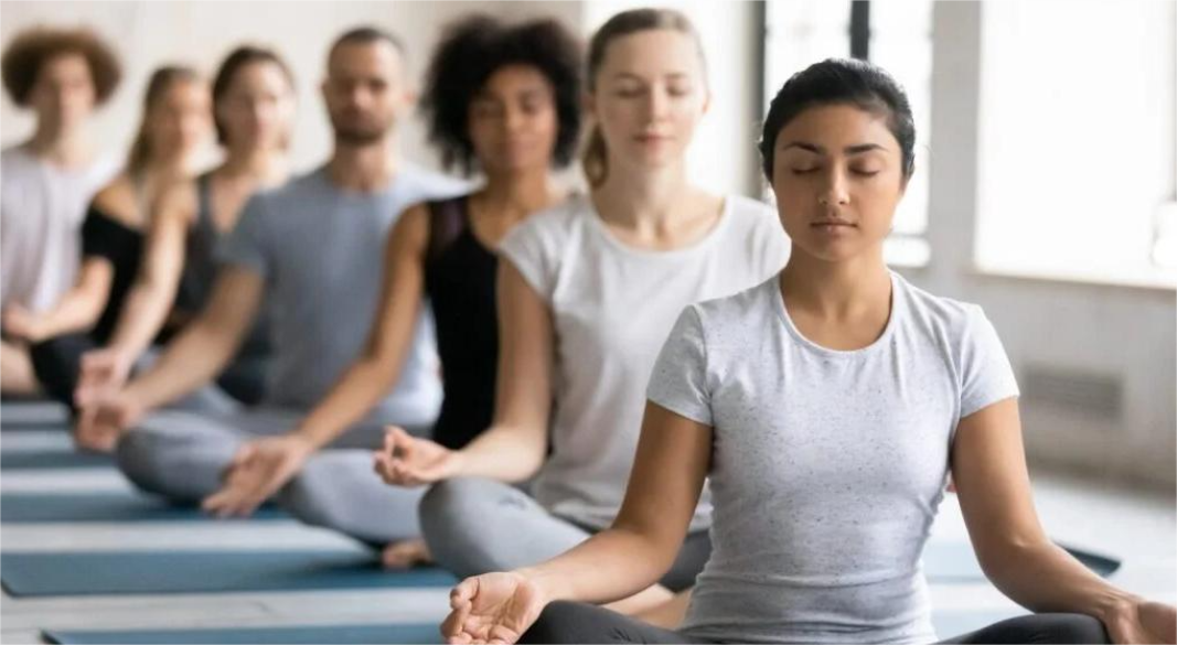 A person practicing yoga outdoors, meditating and stretching for holistic wellness.