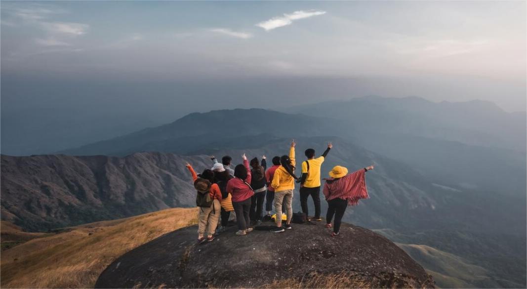 Group of hikers on a mountain trail during sunrise