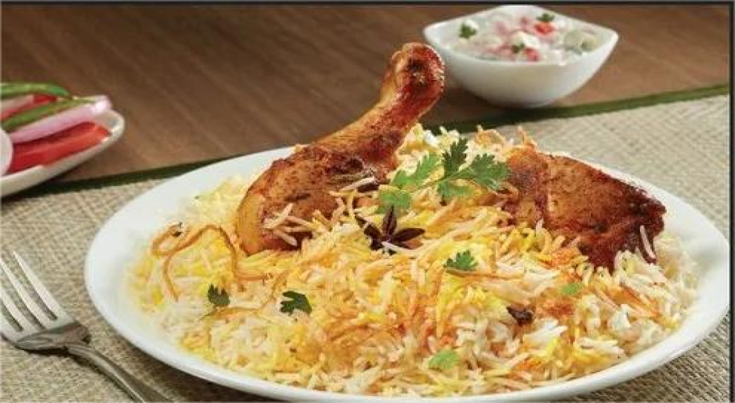 Authentic Hyderabadi Chicken Biryani served in a traditional handi with herbs and saffron rice