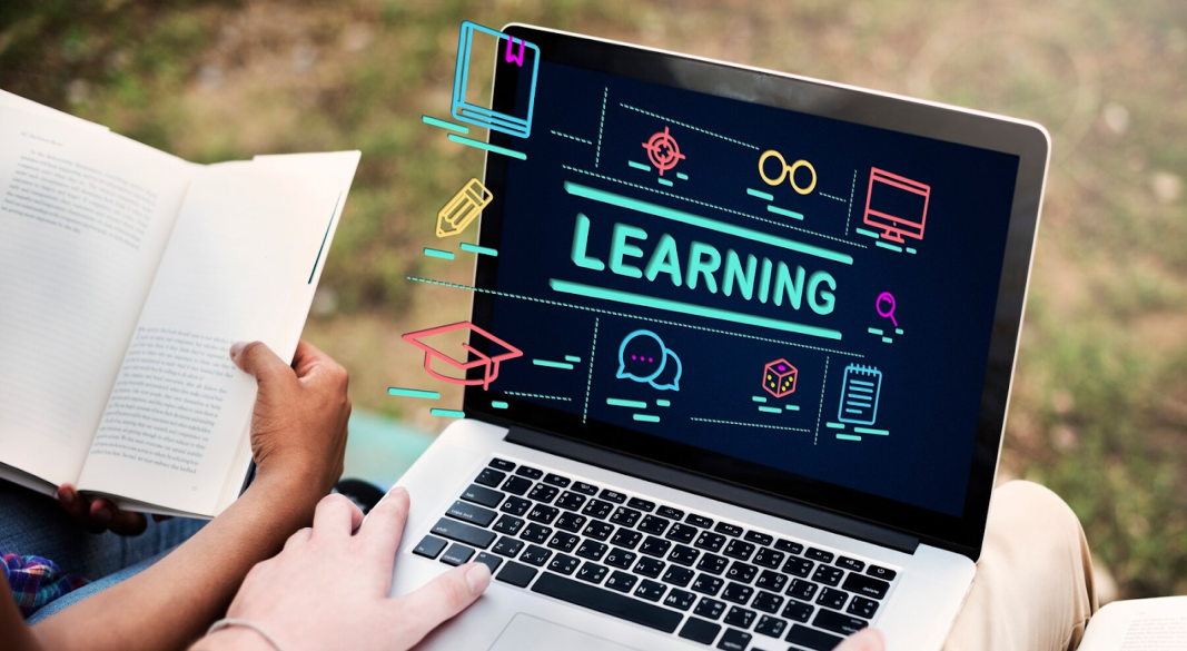 Student comparing top e-learning websites on a laptop
