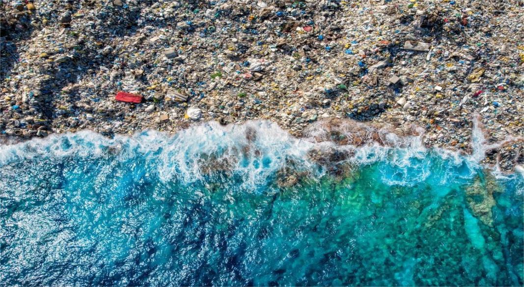 A sea turtle swimming among floating plastic waste in the ocean, symbolizing the threat of single-use plastics to marine life.