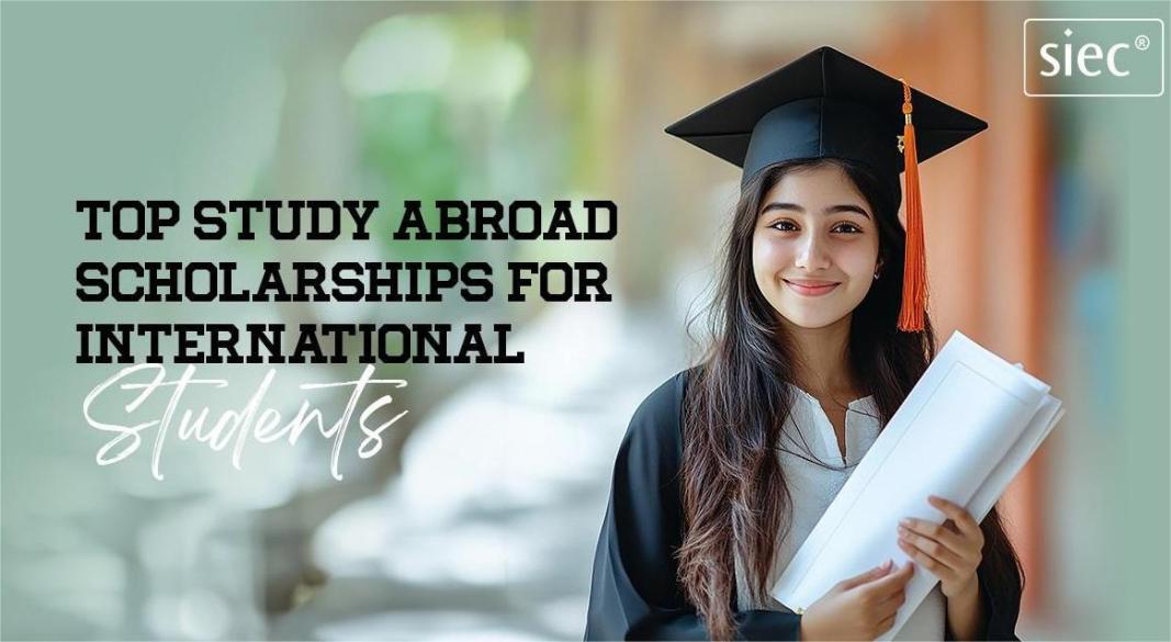 Group of international students holding graduation caps and world flags, representing global scholarship programs.