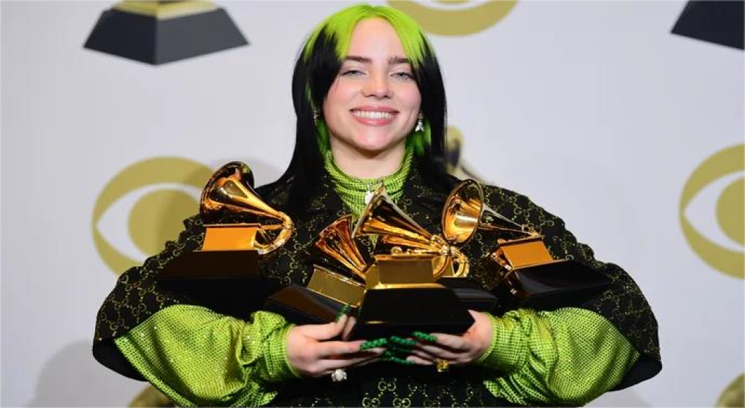 Billie Eilish performing live on stage with signature style