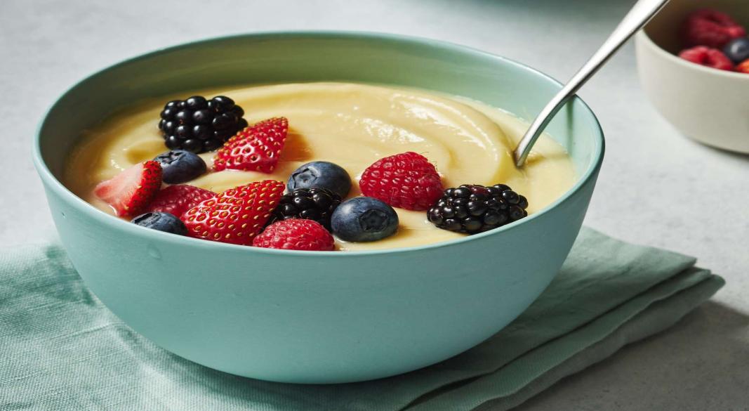 Homemade simple custard served in a bowl with fresh fruits.