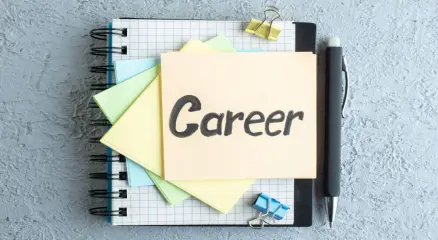 Young professional planning career goals with laptop and notebook