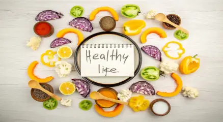 Colorful plate with vegetables, fruits, whole grains, and lean protein, representing balanced nutrition