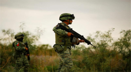 Armed security forces patrolling streets in Mexico with cartel-related graffiti in the background, symbolizing crime and violence