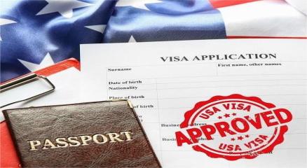 Close-up of passport, visa documents, and travel stamps on a desk