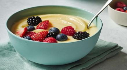 Homemade simple custard served in a bowl with fresh fruits.