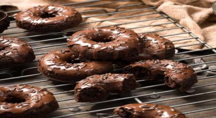 Homemade glazed donuts on a cooling rack